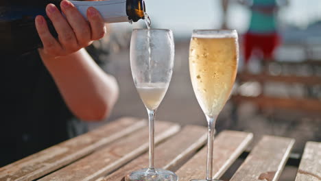 pouring champagne on the beach