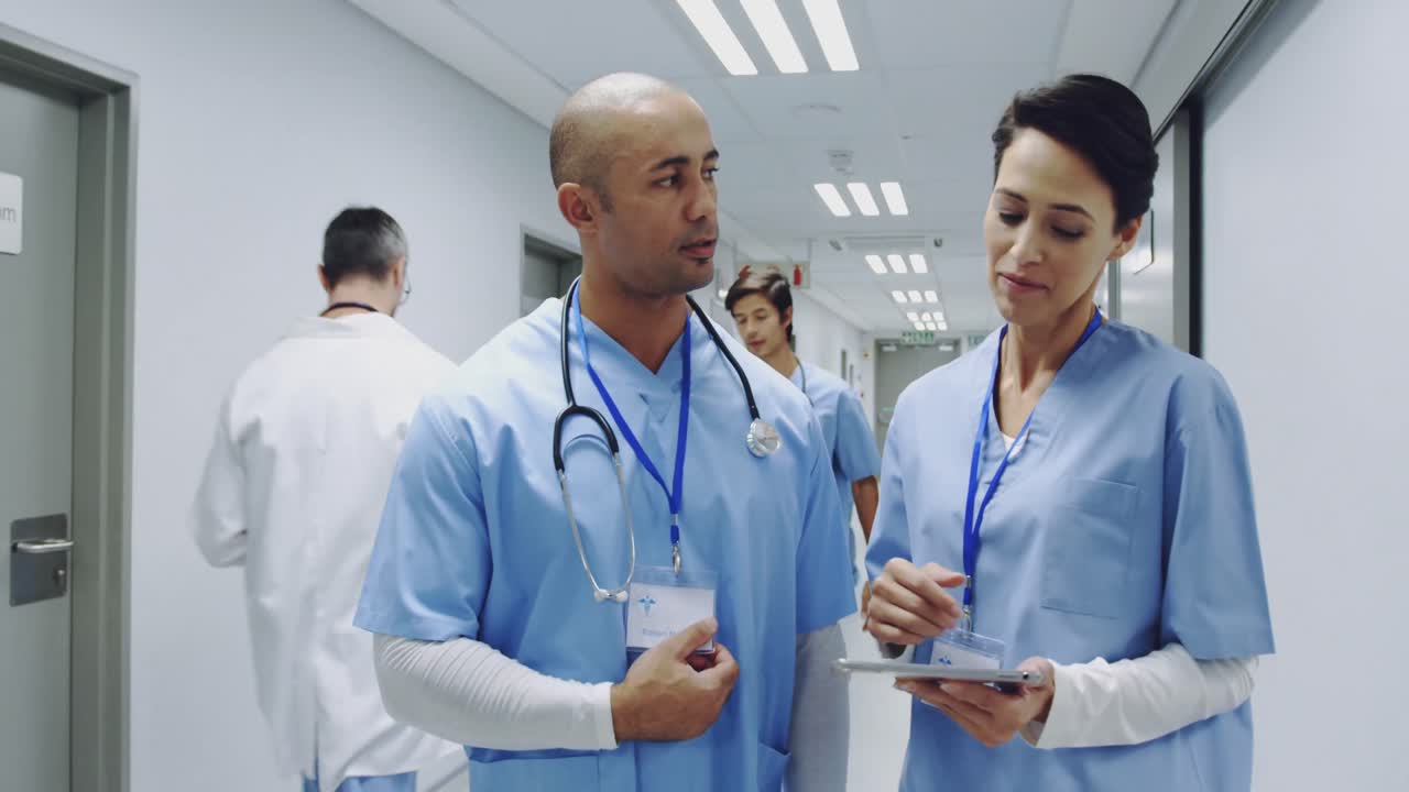 Young doctors consulting in hospital corridor 4k