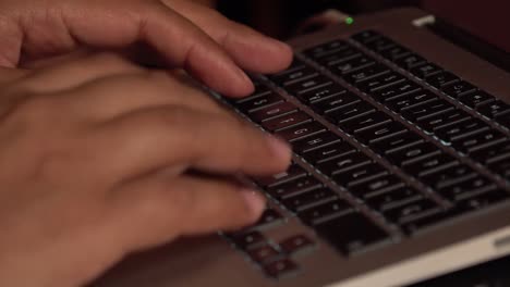 hands typing and clicking on a laptop keyboard