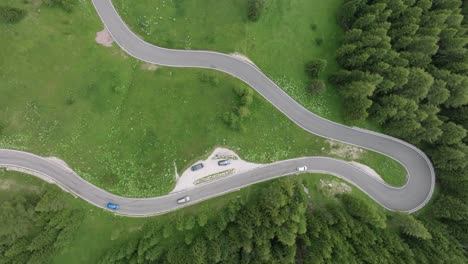 aerial view of vehicles driving on the winding roads near selva pass dolomites mountains, trentino, south tyrol, italy