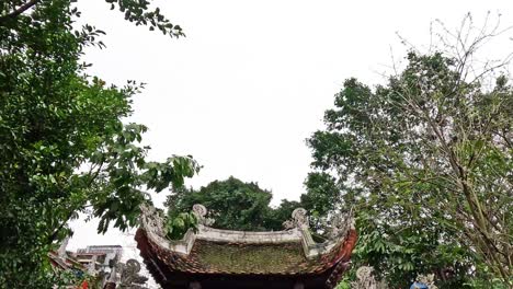 temple entrance with flags and lush greenery