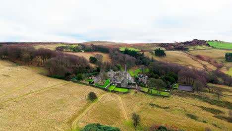 Old-derelict-castle,-monument,-disused-stone-tower,-with-people-walking-around-and-flying-a-drone