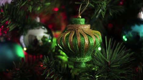 green and gold glitter foami christmas ornament, hanging from the tree