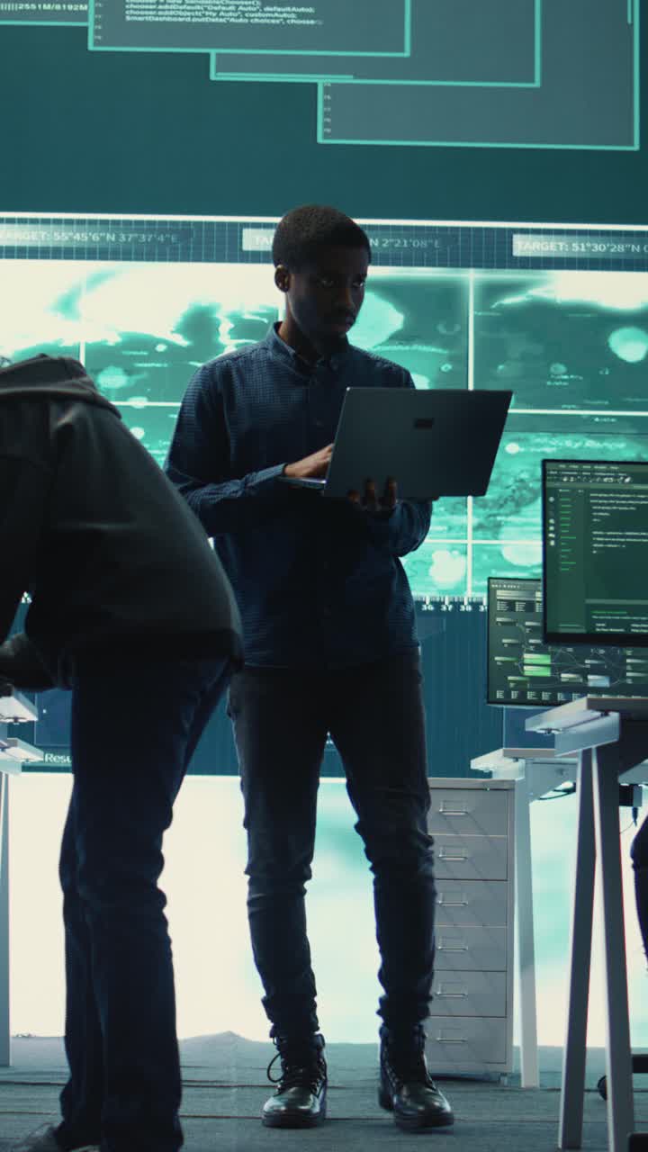 African American Man Working on Laptop in High-Tech Office