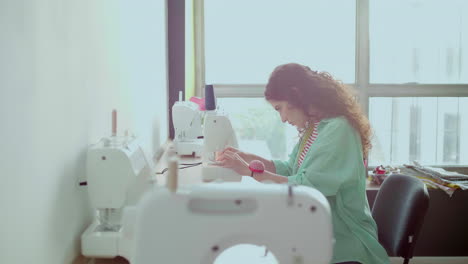 dressmaker using sewing machine.