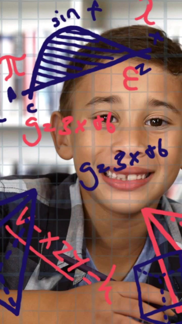 Vertical video: Student writing with pencil hearing offscreen cue and smiling, math grid overlay