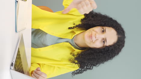 Vertical-video-of-Negative-expression-of-young-woman-using-laptop.