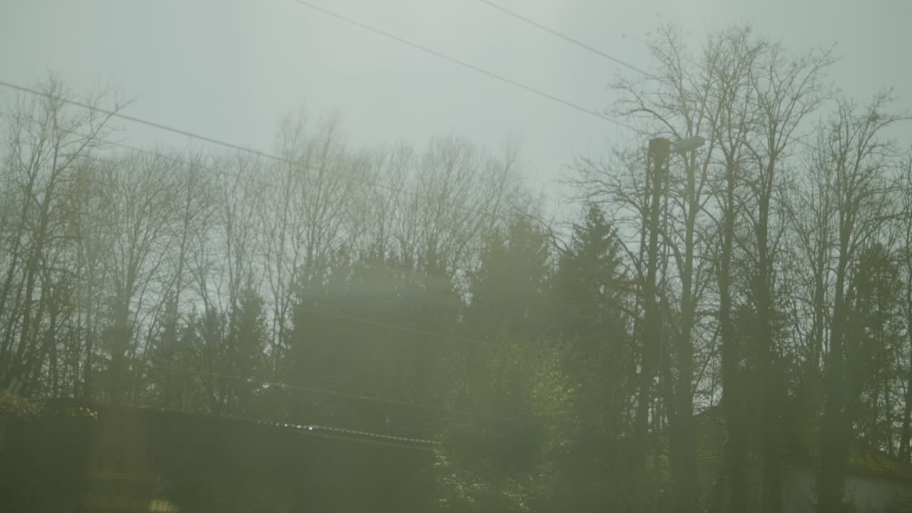 Inside an ICE high-speed train, showing blurry view through the window and power lines