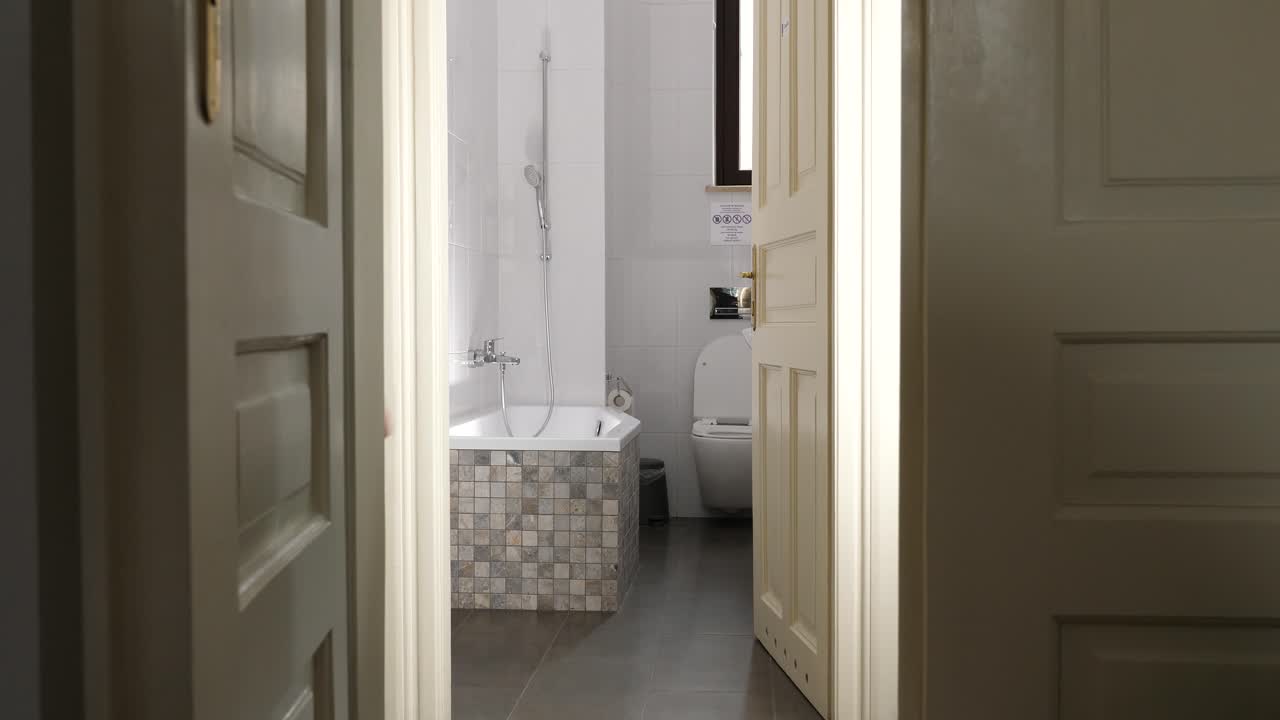 Woman standing in a bathroom doorway