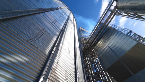 modern complex for agribusiness. large storage container. industrial equipment for drying grains. metal construction for storing crop. industry outdoors.