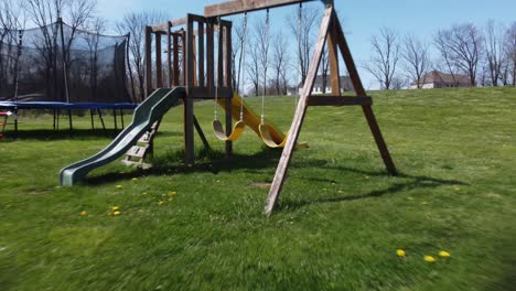 kids swingset in green grass