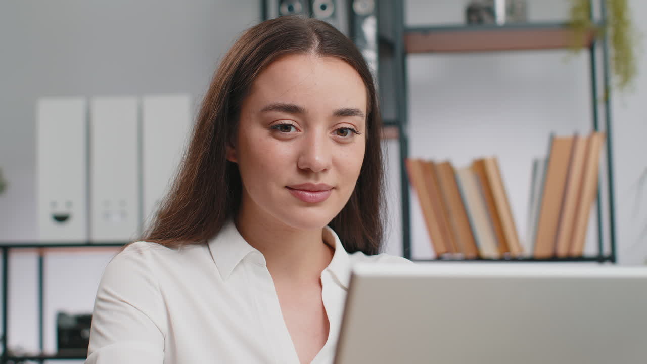 Closeup businesswoman freelancer at office workplace works on laptop computer sends online messages