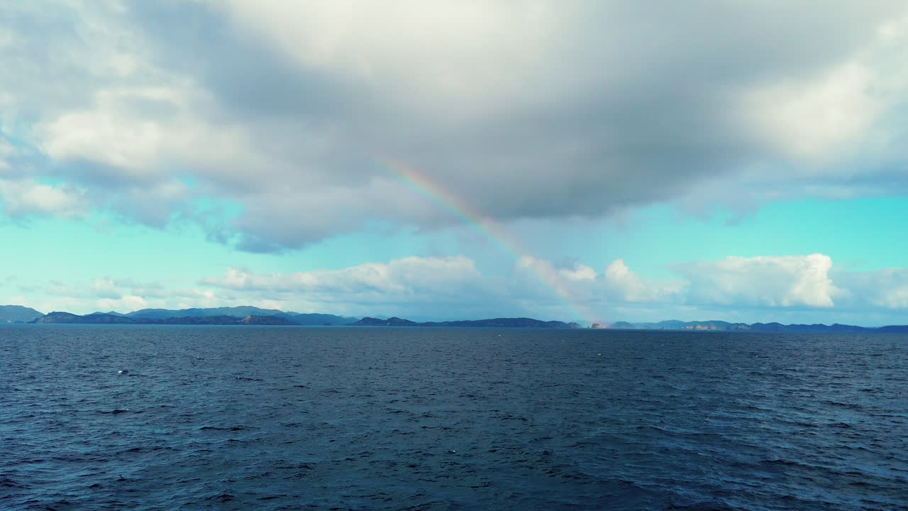 Epic Rainbow Through Clouds Over Bay Of Islands In New Zealand - wide shot, slow motion