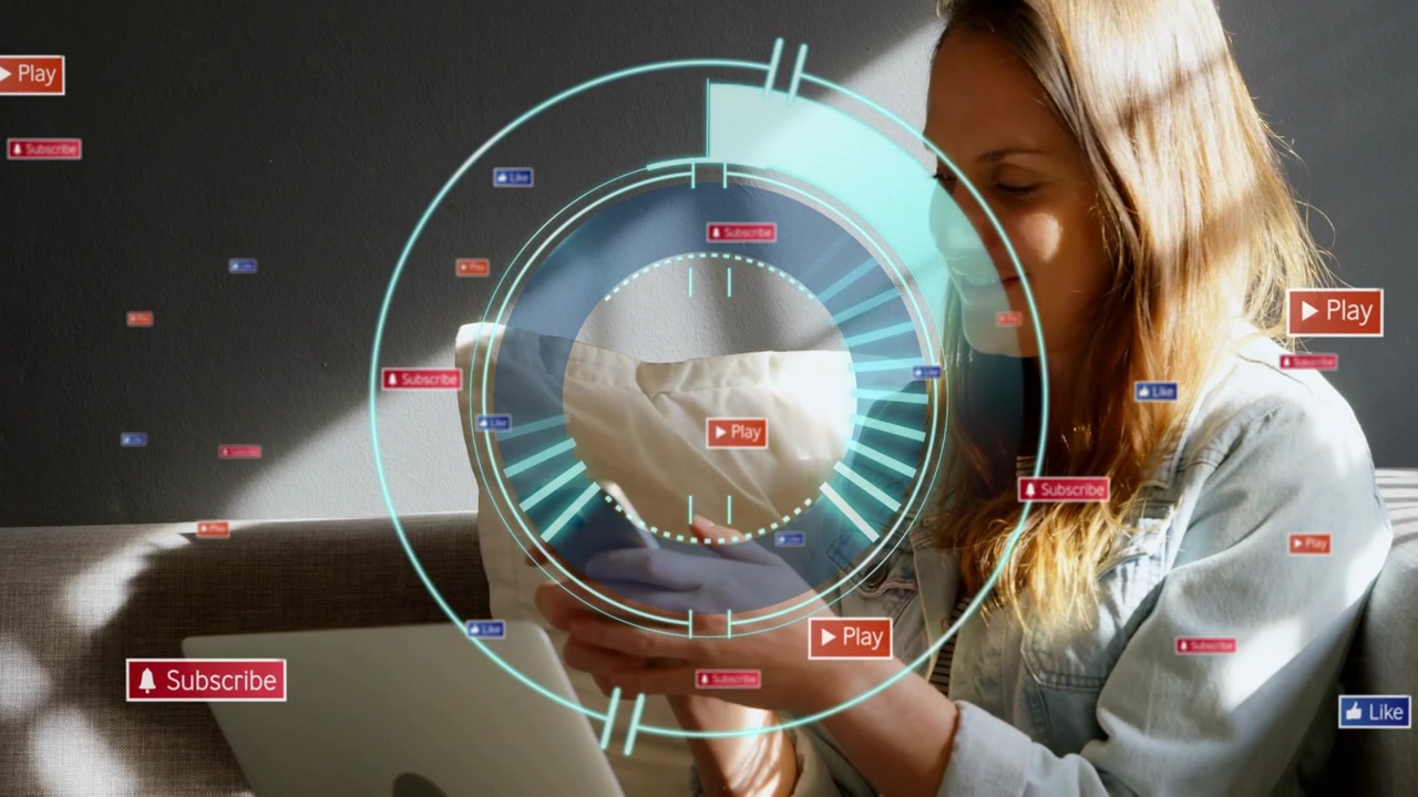Woman on couch tapping phone activating HUD, floating play icons, typing laptop for social media