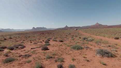 operador de aviones fpv divirtiéndose controlando su dron con la torre del desierto de roca roja en el fondo