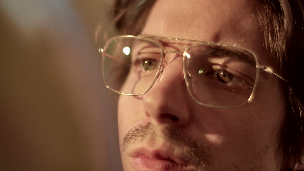 Close-up of a person's eyes and face, wearing glasses