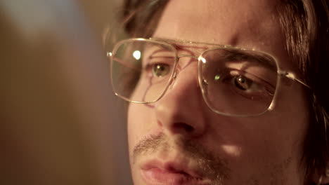 close-up of a person's eyes and face, wearing glasses