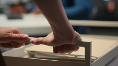 vertical video close up of office secretary pushes trolley filled with paperwork and documents