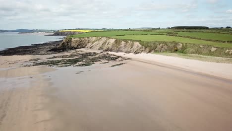 Drone-shot-flying-backwards-over-two-beaches-