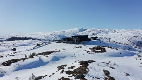 amazing scenic shot of gondola cabins leaving and arriving hangurstoppen mountain station at voss - norway