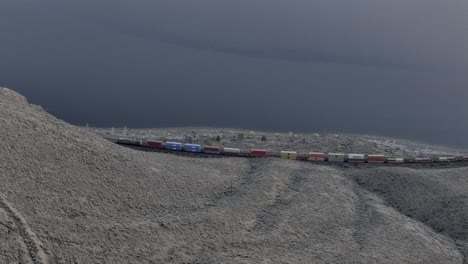 Railway-Rhapsody:-Bird's-Eye-Drone-Symphony-Over-Kamloops-Lake,-Desert-Grassland,-and-Cliffside-Train-Drama