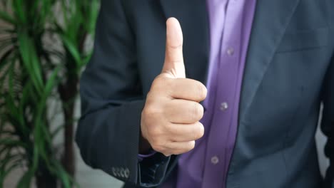 man in suit giving thumbs up