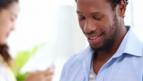 Casual-business-colleagues-using-tablet-and-smartphone