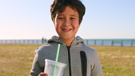 boy, face and drinking by the ocean on a leisure