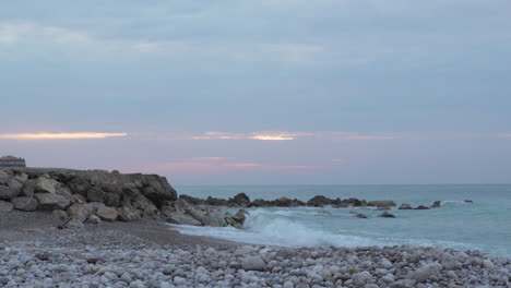 time-lapse-captures-man-taking-photos-during-overcast-golden-hour-during-wild-sea