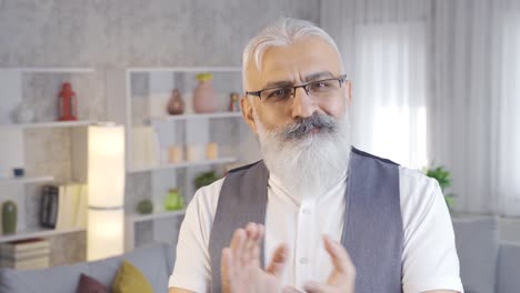 mature man looking at camera and applauding and congratulating.