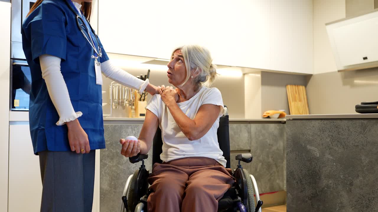 Nurse Assisting Elderly Woman in Wheelchair at Home