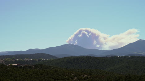 massive wildfire looming over small mountain town in new mexico usa