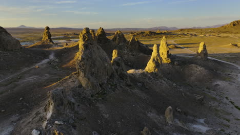 Aerial-view-around-rocky,-desert-cliffs,-sunset-in-Alabama-Hills,-California,-USA