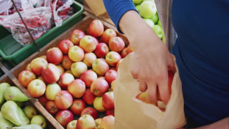 Close-Up-Of-Female-Customer-Using-Plastic-Free-Paper-Bag-To-Buy-Fresh-Produce-In-Organic-Farm-Shop