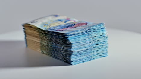 clockwise rotation of 20 euro notes stack symbolizing finance and transaction