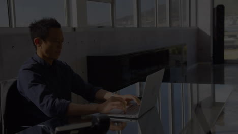 animation of asian businessman using laptop in office