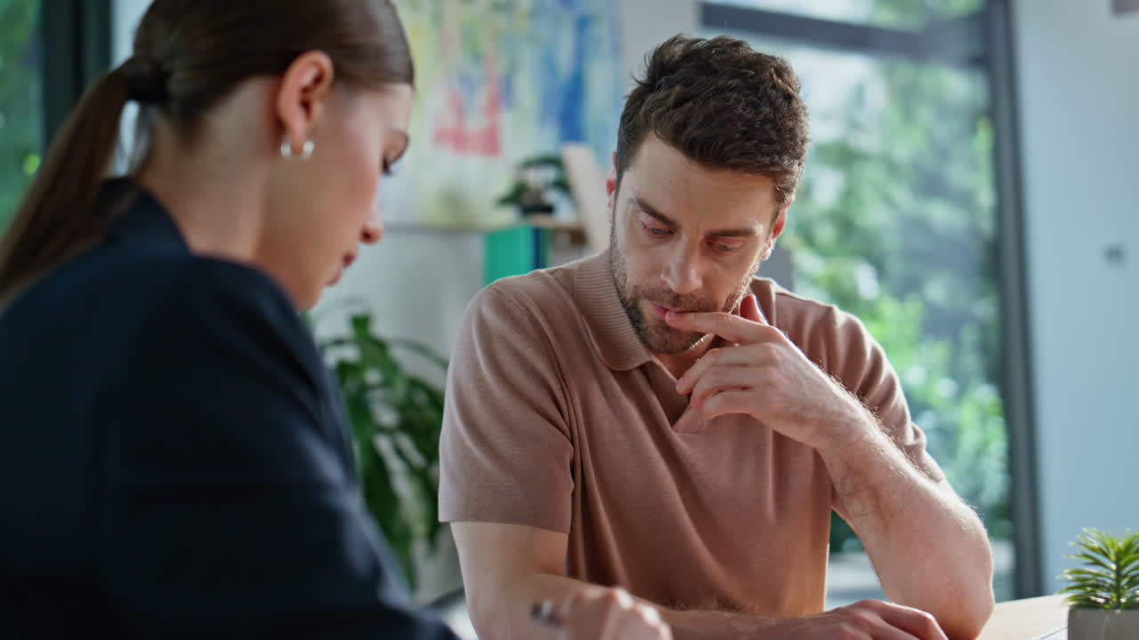 Consultant making loan calculations to businessman at corporate office closeup