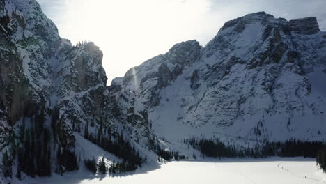 Sonnendurchflutete-Verschneite-Winterberglandschaft,-Zugefrorene-Pragser-Wildsee,-Dolomiten