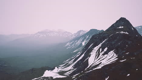 snowy mountain landscape under overcast sky in remote wilderness area