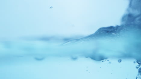 smooth waves roll across the surface of clear blue water, capturing the serene and flowing essence of natural, fresh liquid.