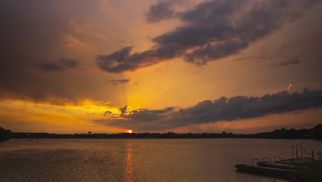 Wind-blows-across-open-lake-as-storm-clouds-form-out-of-thin-air,-yellow-rays-of-light-condense