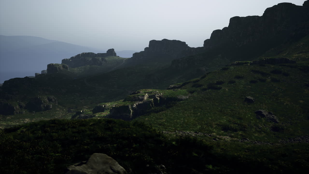 Mountainous landscape with rocky formations and greenery during dusk