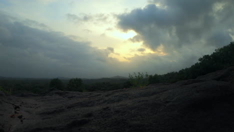 A-4k-time-lapse-video-of-a-beautiful-horizon-landscape,-forest-and-moving-clouds-from-a-top-view