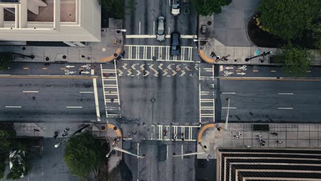 Top-down-aerial-tracking-shot-of-cars-driving-on-one-one-way-street-at-Peachtree-Center,-Downtown-Atlanta,-Georgia,-USA