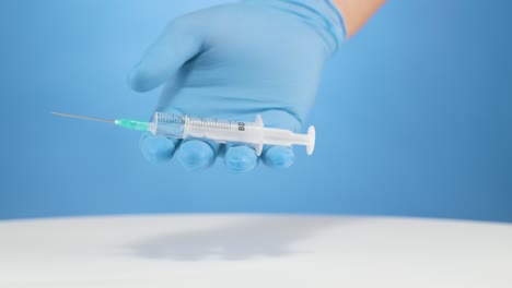 Establish-a-medical-injection-needle,-healthcare-utensil,-studio-blue-background