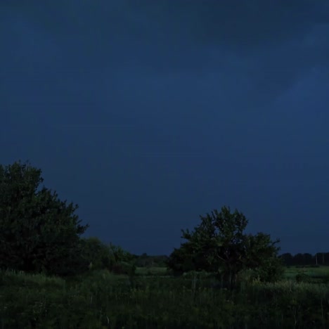 lightning strikes on the dark sky. stormy sky with lightning flashing over green nature in the evening. dark blue sky becomes light with a lightning splash in summer.