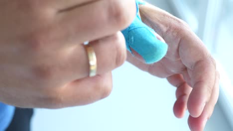 man taking kinesiology tape off his thumb