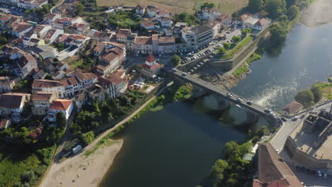 Barcelinhos-and-Barcelos-riverside-view-crossed-by-the-Medieval-Bridge-aerial-shot---Orbit