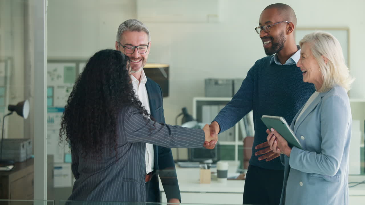 Diverse Business Team Shaking Hands and Discussing in Modern Office