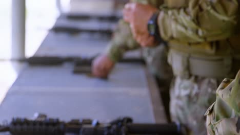 Side-view-of-caucasian-military-soldiers-loading-weapon-during-training-4k